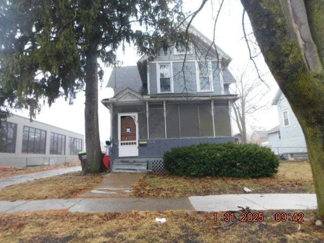 view of front of property featuring a sunroom