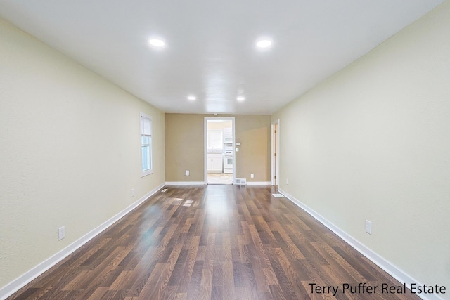 unfurnished room with dark hardwood / wood-style floors