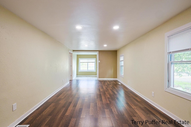 unfurnished room featuring dark wood-type flooring