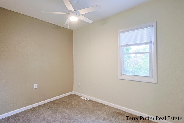 empty room with ceiling fan and carpet floors