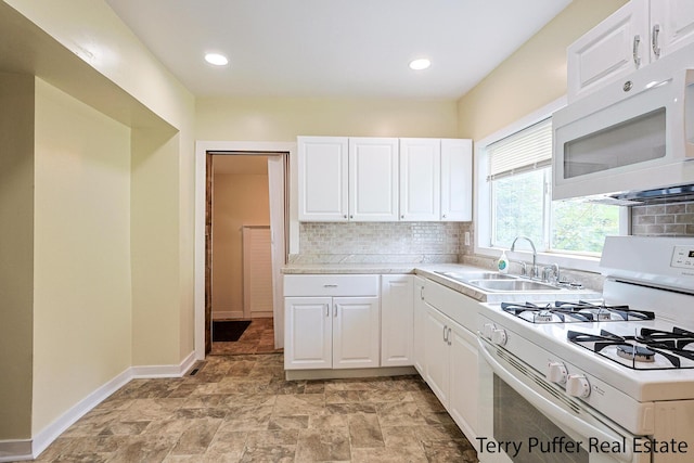 kitchen featuring sink, white appliances, decorative backsplash, and white cabinets