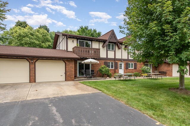 5410 Country Aire Dr Unit 13, Coloma, MI 49038 - tudor-style house featuring a balcony, a garage, and a front lawn