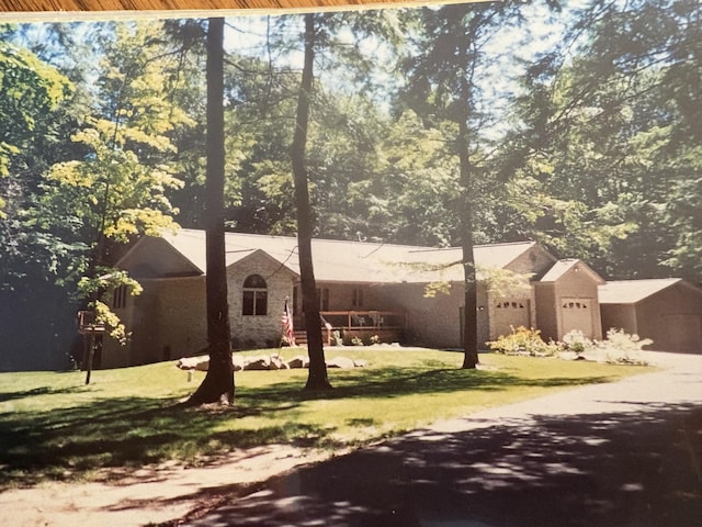 view of front of house with a garage and a front yard