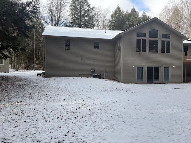 view of snow covered back of property