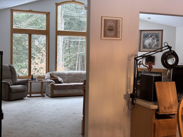 living room featuring vaulted ceiling and carpet floors