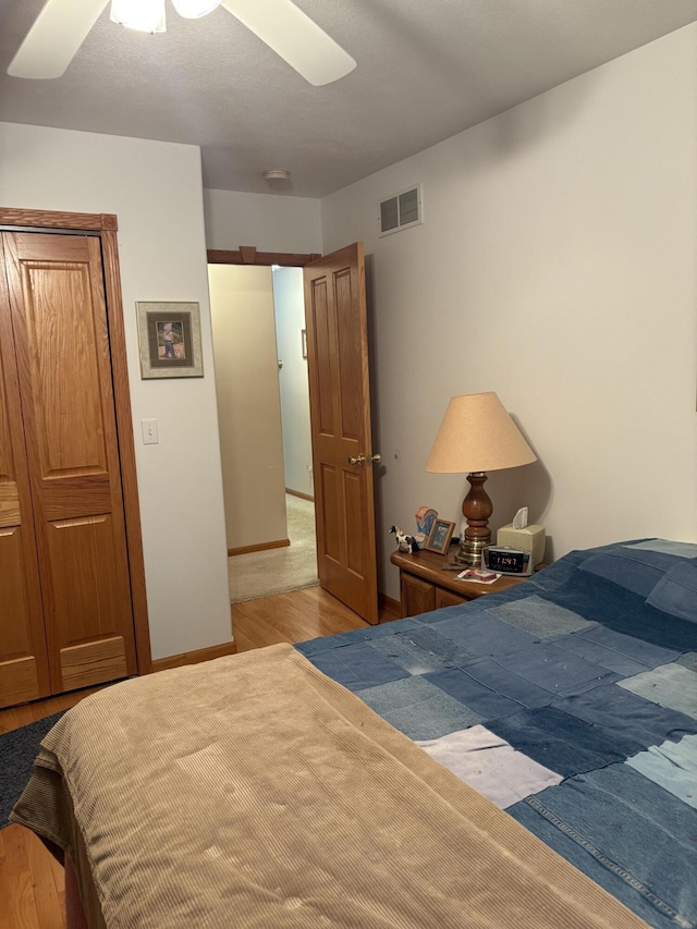 bedroom with ceiling fan and light hardwood / wood-style floors