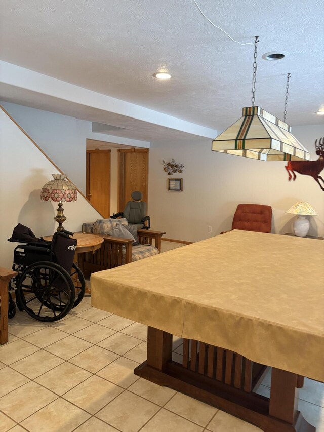 recreation room featuring light tile patterned flooring, a textured ceiling, and billiards