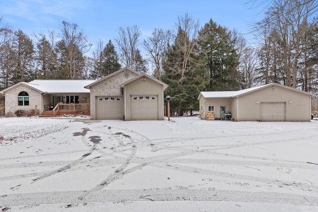 view of snow covered exterior featuring a garage and a porch