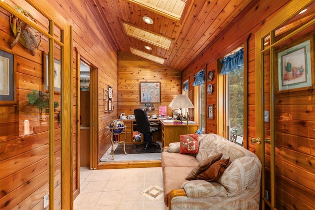 office space with light tile patterned flooring, wooden ceiling, vaulted ceiling with skylight, and wood walls