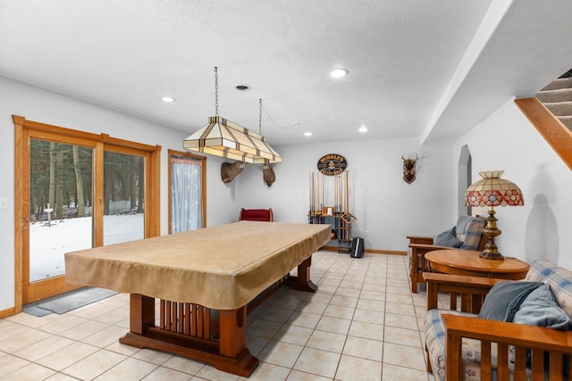 recreation room with light tile patterned floors, billiards, and a textured ceiling