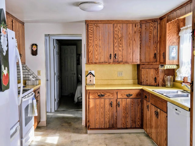 kitchen with white appliances and sink