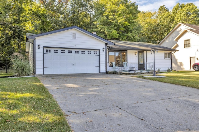 view of front of property with a garage, a porch, and a front lawn