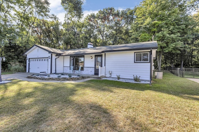 ranch-style home featuring cooling unit, a garage, covered porch, and a front lawn