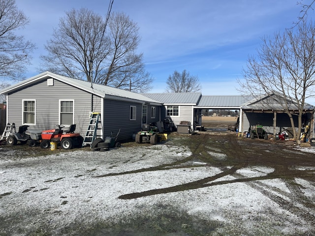 view of snow covered back of property