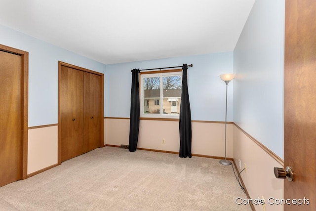 unfurnished bedroom featuring light carpet