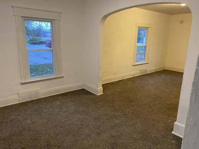 empty room with dark carpet