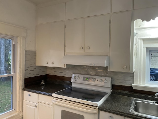 kitchen with tasteful backsplash, sink, white cabinets, and white range with electric stovetop