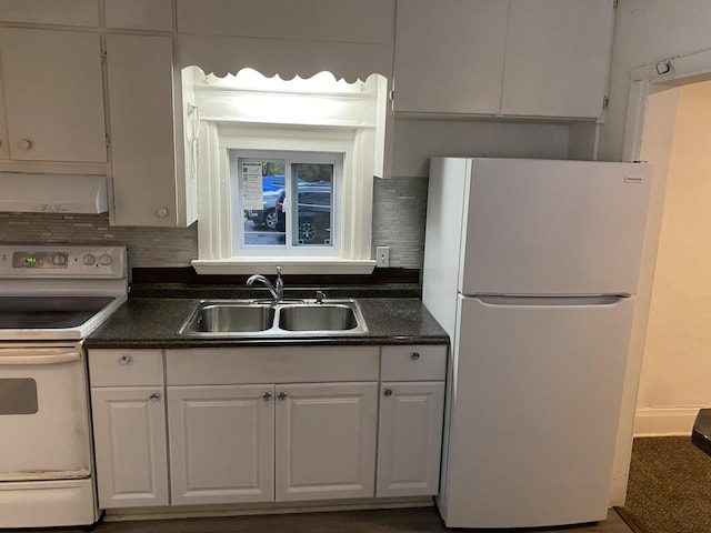 kitchen featuring sink, backsplash, white cabinets, wall chimney range hood, and white appliances