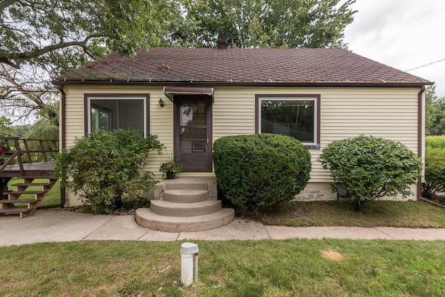 bungalow-style home featuring a front yard