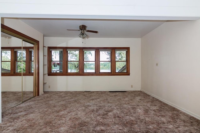 spare room featuring carpet floors and ceiling fan