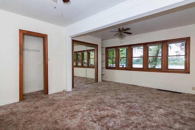 unfurnished bedroom featuring ceiling fan and carpet floors