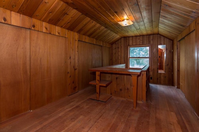 interior space featuring vaulted ceiling, dark hardwood / wood-style floors, wooden ceiling, and wooden walls