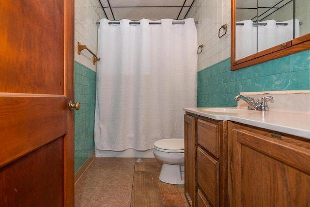 full bathroom featuring shower / bathtub combination with curtain, tile walls, vanity, wood-type flooring, and toilet