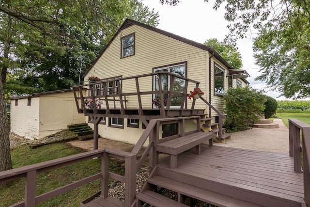 back of house featuring a wooden deck