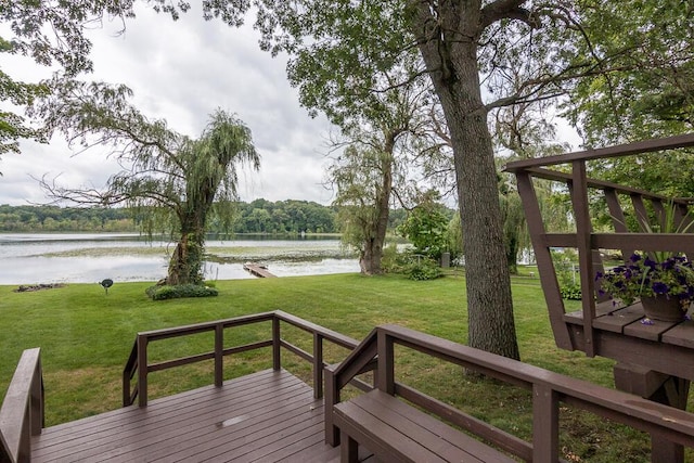 wooden terrace featuring a lawn and a water view