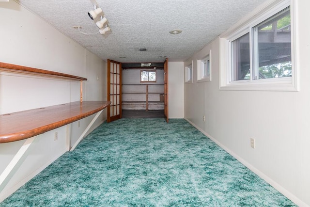 basement with carpet floors and a textured ceiling