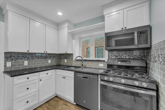 kitchen with dark hardwood / wood-style flooring, sink, white cabinets, and appliances with stainless steel finishes