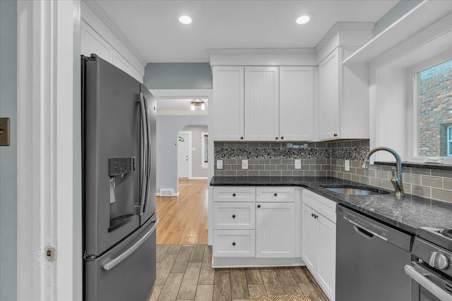 kitchen featuring stainless steel fridge with ice dispenser, sink, white cabinets, and black dishwasher