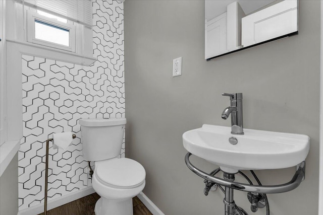 bathroom featuring hardwood / wood-style floors and toilet