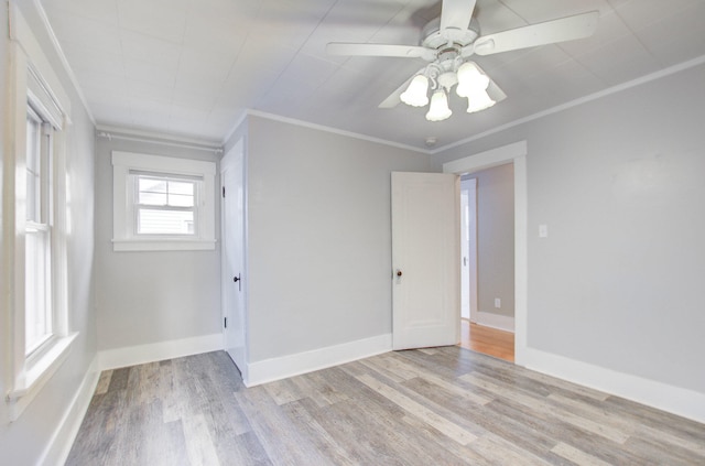 spare room with crown molding, ceiling fan, and light hardwood / wood-style floors