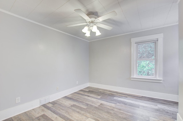 empty room featuring ornamental molding, ceiling fan, and light wood-type flooring