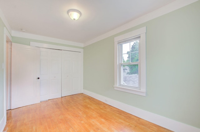 unfurnished bedroom featuring light hardwood / wood-style flooring and a closet