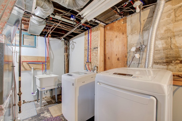 washroom featuring washing machine and dryer and sink