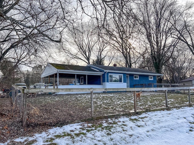 view of snow covered back of property