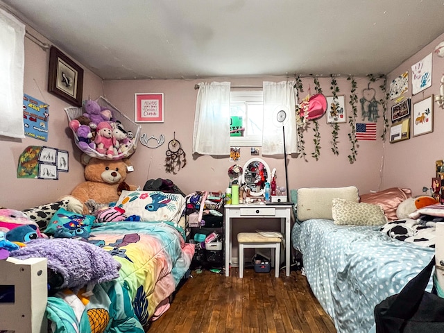 bedroom with dark wood-type flooring