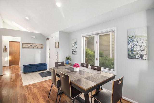 dining room featuring lofted ceiling and wood-type flooring