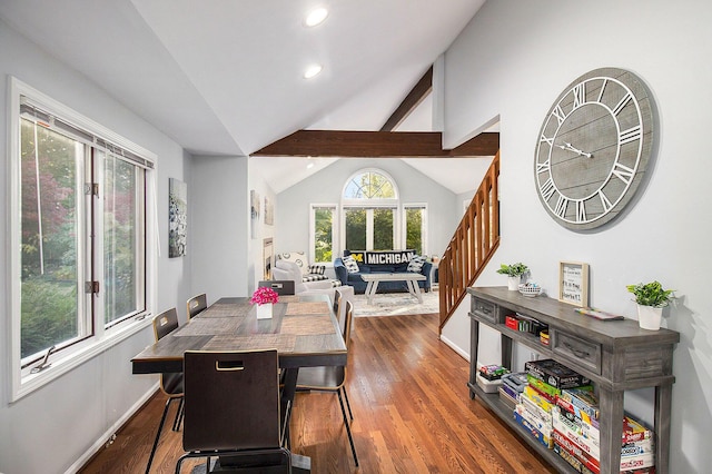 dining space with lofted ceiling with beams and dark hardwood / wood-style floors