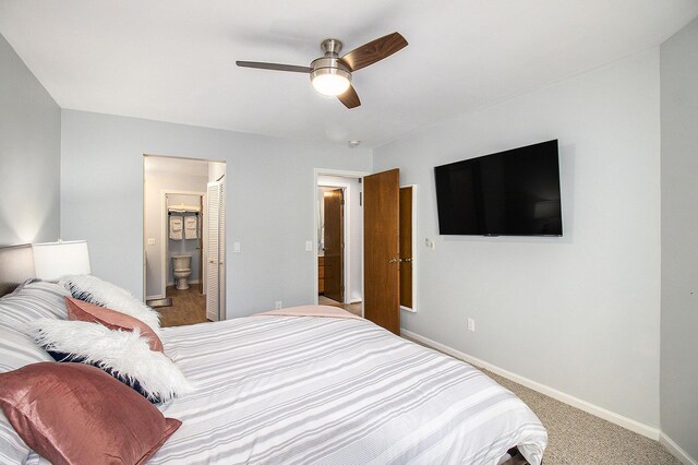 bedroom featuring ensuite bathroom, carpet, and ceiling fan