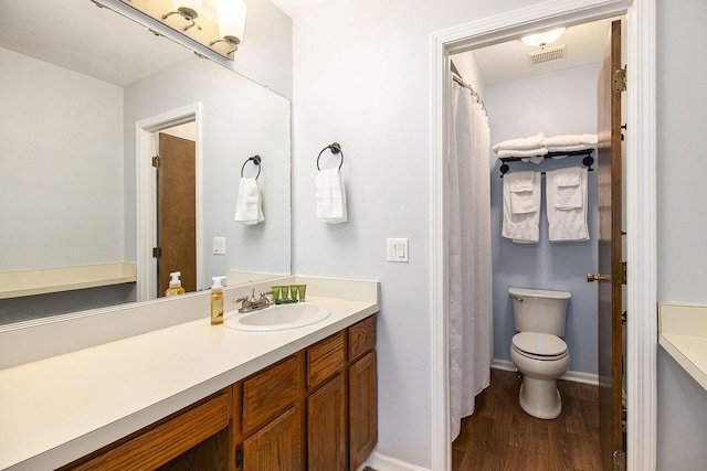 bathroom with vanity, hardwood / wood-style flooring, and toilet