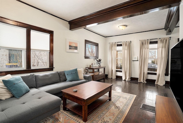 living room with beamed ceiling, ornamental molding, and dark hardwood / wood-style floors