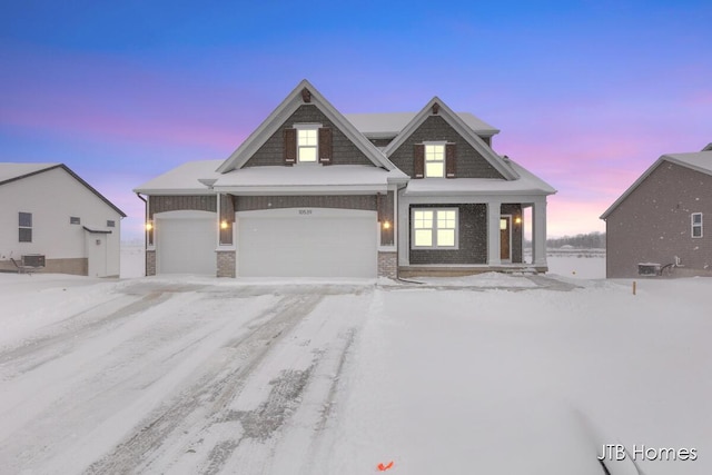 view of front of home featuring an attached garage and brick siding