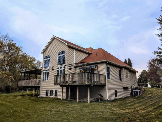 168 Pheasant Run, Battle Creek, MI 49015 - back of house featuring central air condition unit, a sunroom, a yard, and a deck