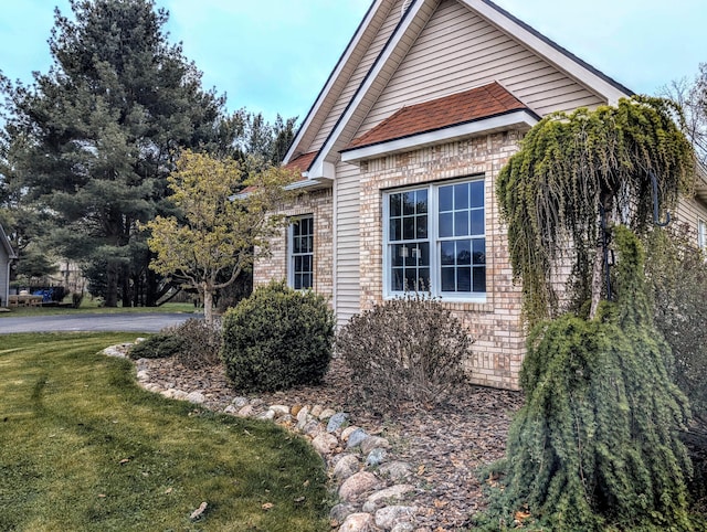 168 Pheasant Run, Battle Creek, MI 49015 - view of home's exterior featuring a lawn and brick siding