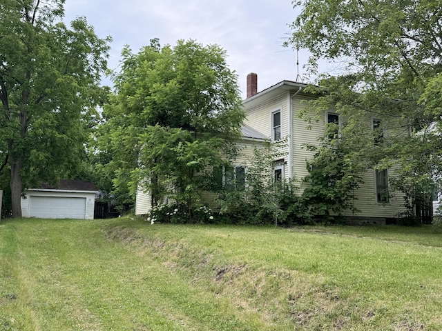 view of yard featuring an outbuilding and a garage