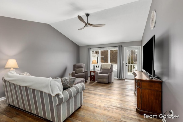 living room featuring vaulted ceiling, hardwood / wood-style floors, and ceiling fan