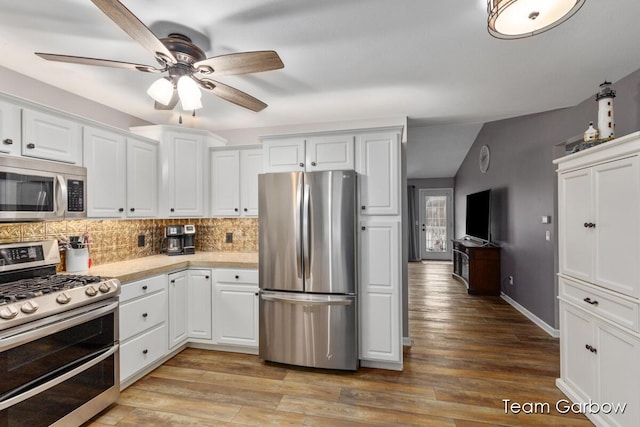 kitchen with tasteful backsplash, stainless steel appliances, light hardwood / wood-style floors, and white cabinets